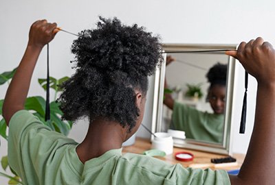 afro_american_admiring_hair_in_mirror