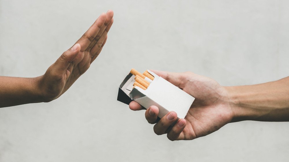 close-up-hands-person-refusing-smoke-cigarette-negative-attitude-smoking-quitting-smoking-concept-hand-is-refusing-cigarette-offer (1)-min