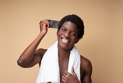 man_brushing_his_afro_hair_after_afro_hair_transplant_in_turkey