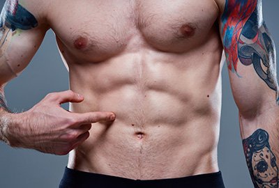 man_showing_abs_after_six_pack_surgery_in_turkey