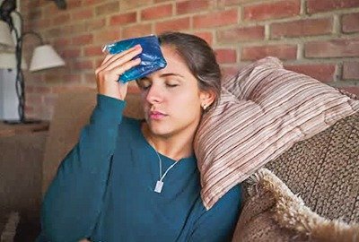 woman_applying_cold_compress_after_coronal_brow_lift_turkey