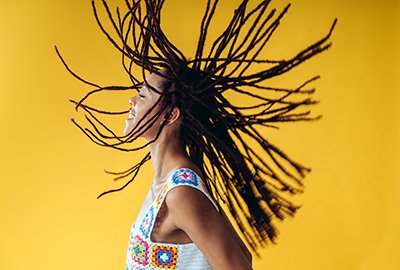 woman_whipping_locs_after_afro_hair_transplant_in_turkey